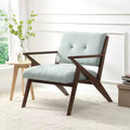 Un fauteuil de salon de style moderne du milieu du siècle avec une assise moelleuse, des accoudoirs inclinés et un cadre en bois massif.